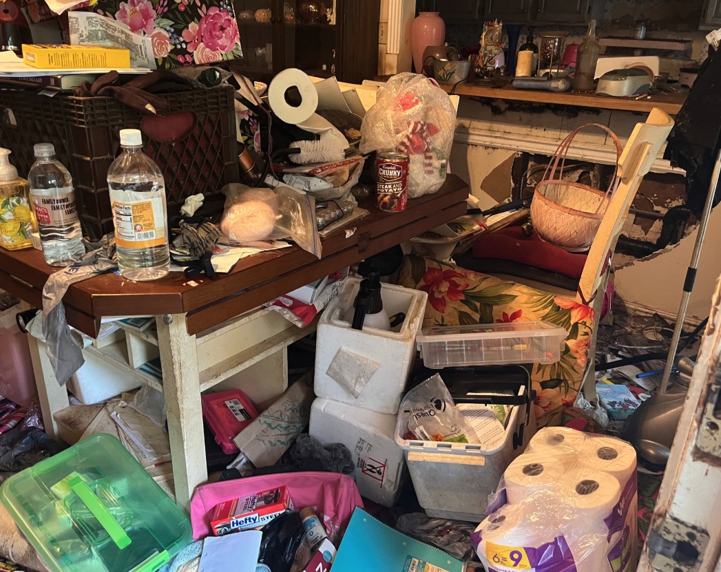 Table and household clutter before Wixom hoarding cleanup sorting