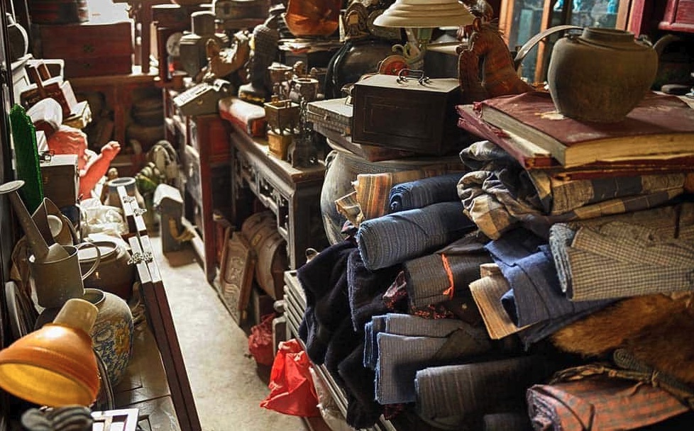 Dark packed storage room before Wixom hoarding cleanup